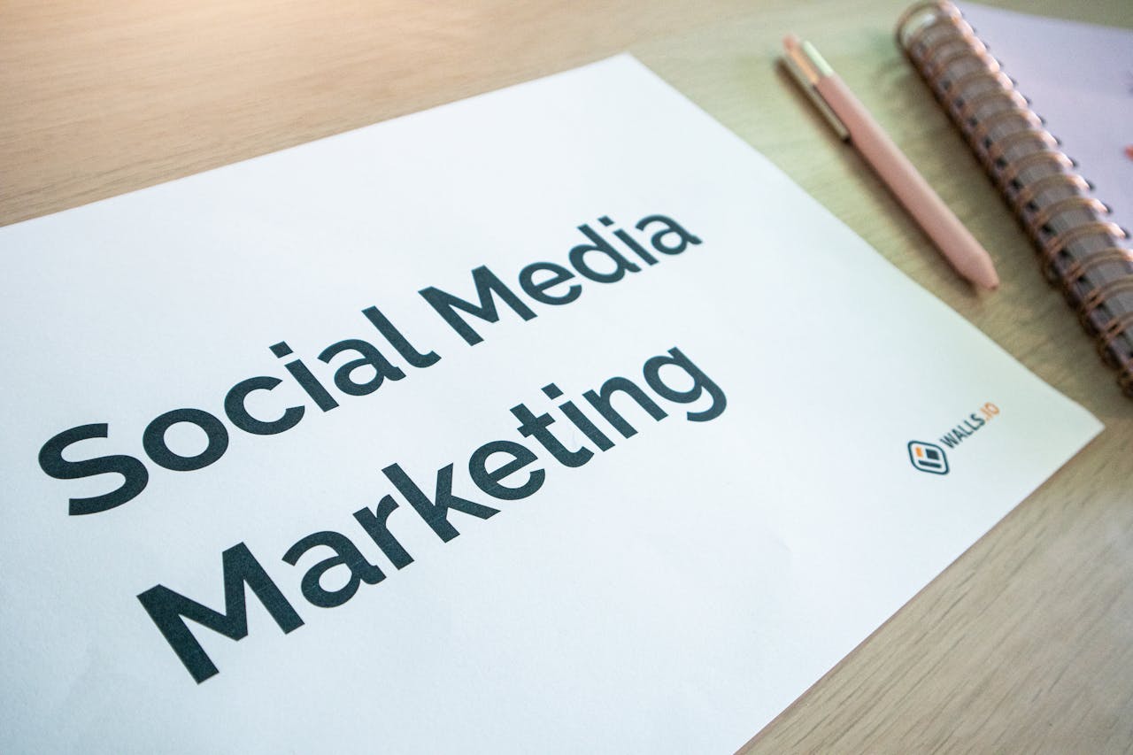 testimonials-img Close-up of a social media marketing document on a desk with a pen and notebook.