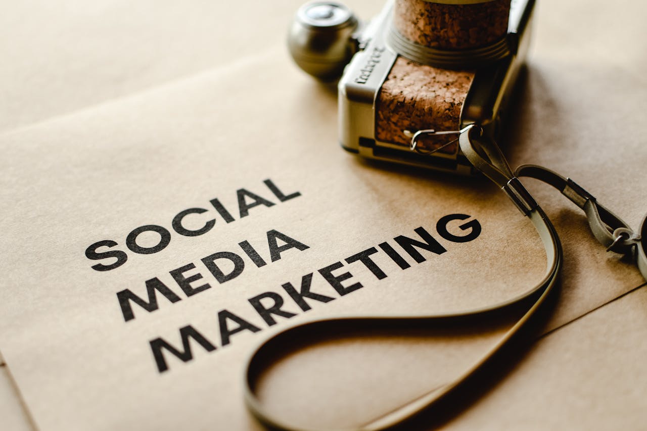 home-services-02 Close-up of a camera placed on brown paper with Social Media Marketing text, emphasizing digital marketing themes.